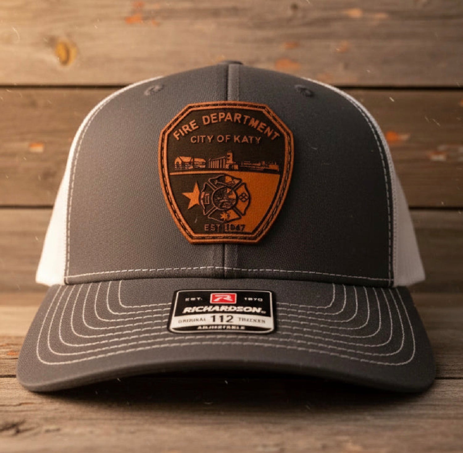 Custom Leather Patch Hats: gray two-tone cap with a genuine brown leather patch for a rugged, elevated look.